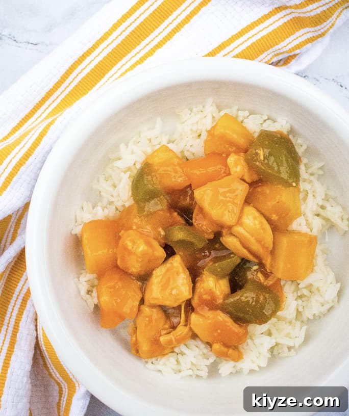 Top Instant Pot Asian Recipes for Flavorful Weeknight Meals 5 Instant Pot sweet and sour chicken over a bed of rice in a white bowl