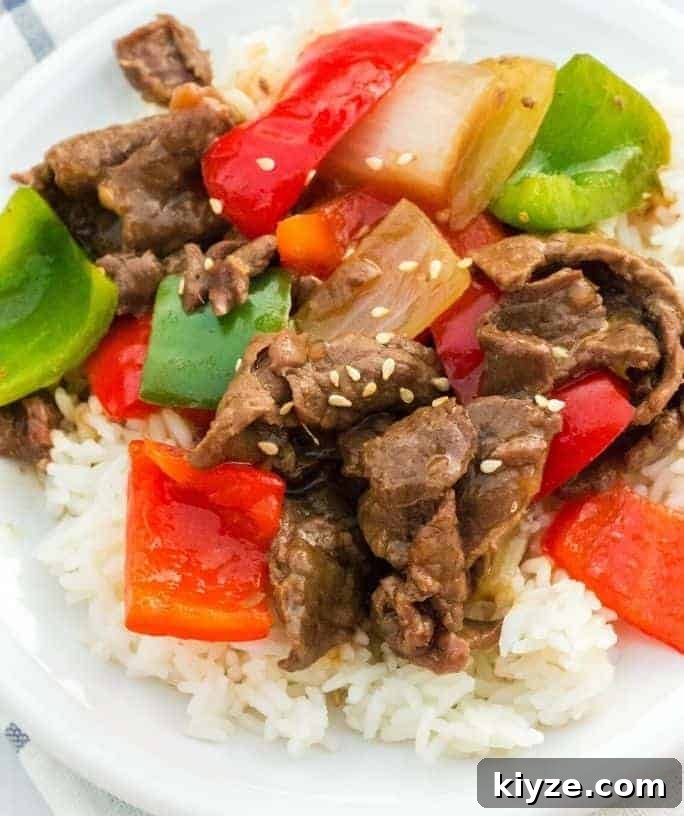 Top Instant Pot Asian Recipes for Flavorful Weeknight Meals 7 Instant Pot pepper steak served over rice on a white plate