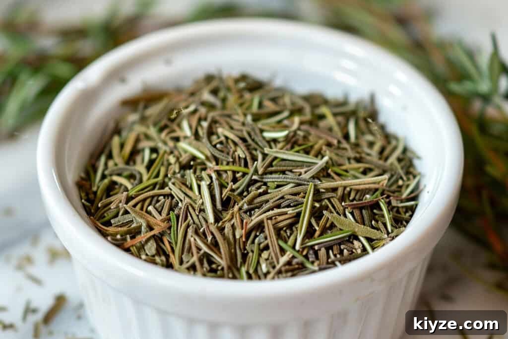 Fresh Rosemary Guide: How to Prep, Cook, and Store Herb Successfully 2 Dried rosemary herbs in a white ceramic bowl with fresh sprigs nearby.