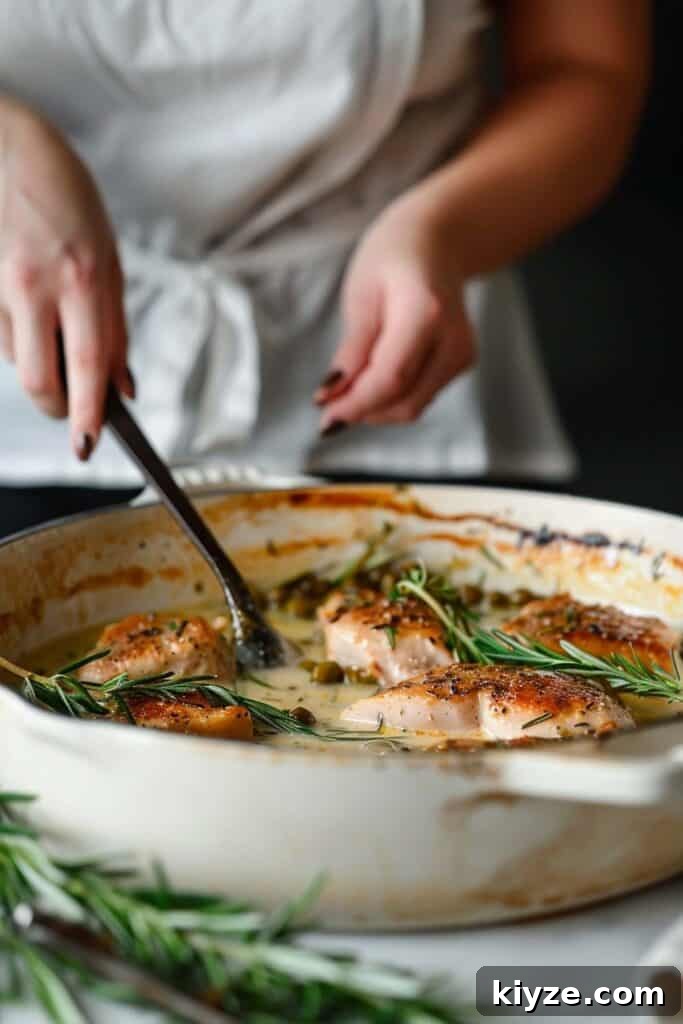 Fresh Rosemary Guide: How to Prep, Cook, and Store Herb Successfully 11 Person serving roasted chicken in a creamy sauce garnished with rosemary.