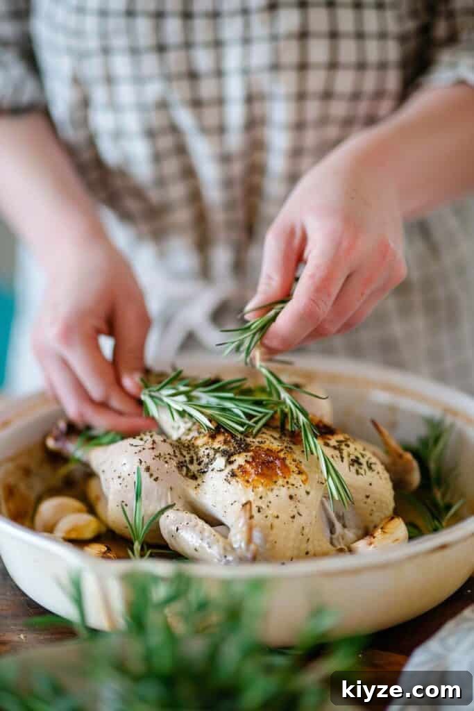Fresh Rosemary Guide: How to Prep, Cook, and Store Herb Successfully 6 Person garnishing a roasted chicken with rosemary.