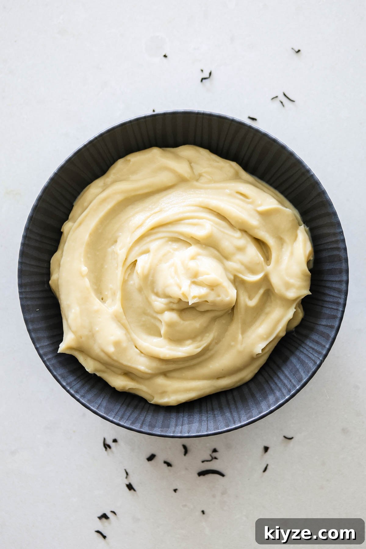 Earl Grey Custard Recipe: Silky Tea-Infused Pastry Cream 2 Earl Grey custard in a black bowl.