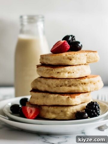 a stack of sourdough pancakes with berries