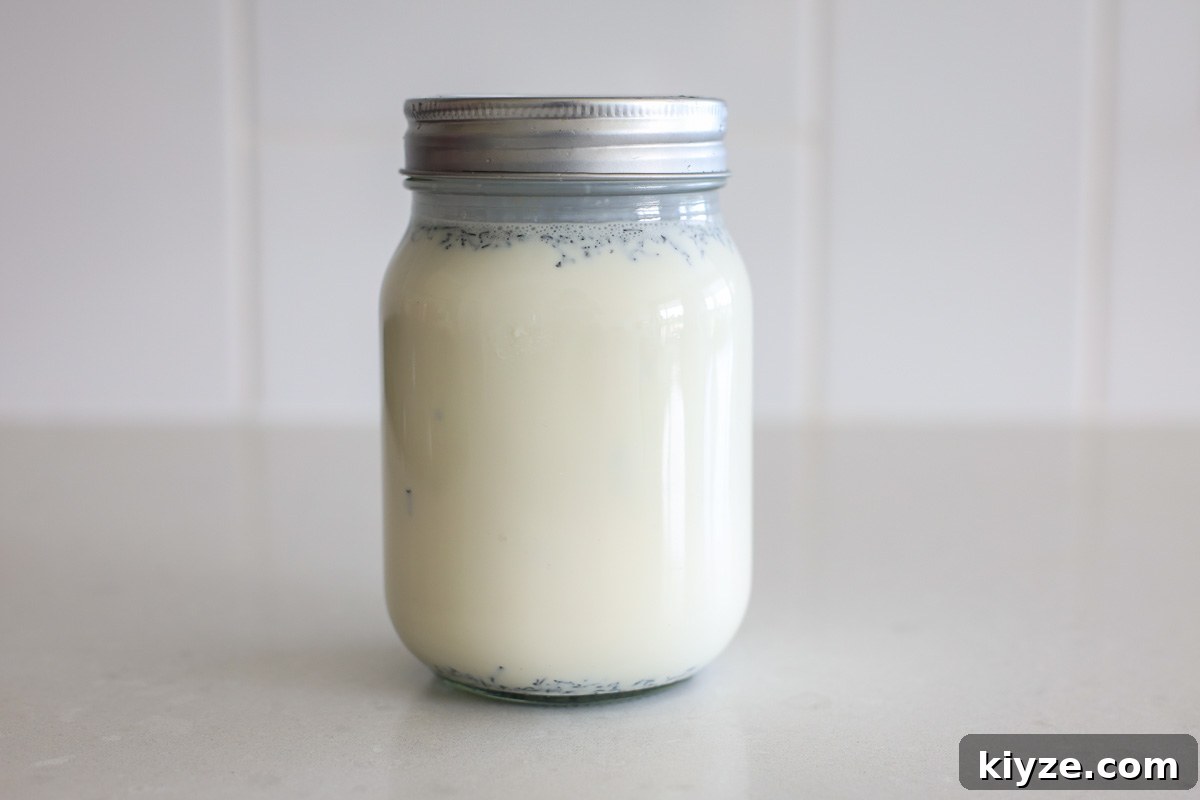 Earl Grey Custard Recipe: Silky Tea-Infused Pastry Cream 4 Cream mixture with Earl Grey loose tea in a glass jar with lid.