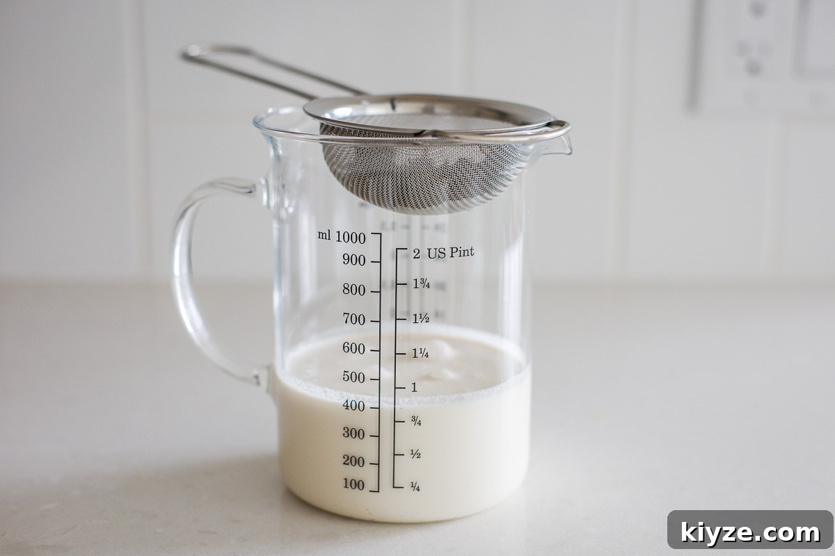 Earl Grey Custard Recipe: Silky Tea-Infused Pastry Cream 5 Cream mixture, fine mesh strainer, and a glass measuring container.