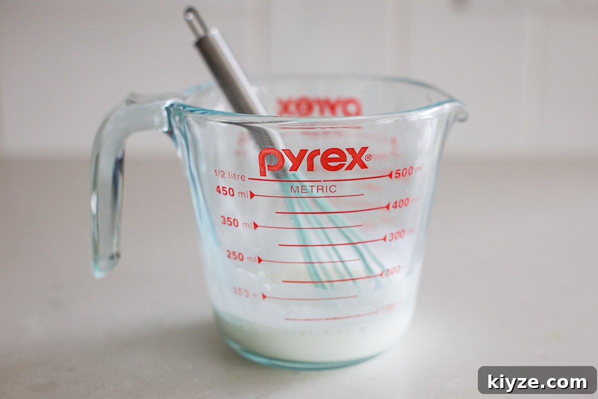Earl Grey Custard Recipe: Silky Tea-Infused Pastry Cream 7 Cornstarch and water in a glass bowl with mini whisk.