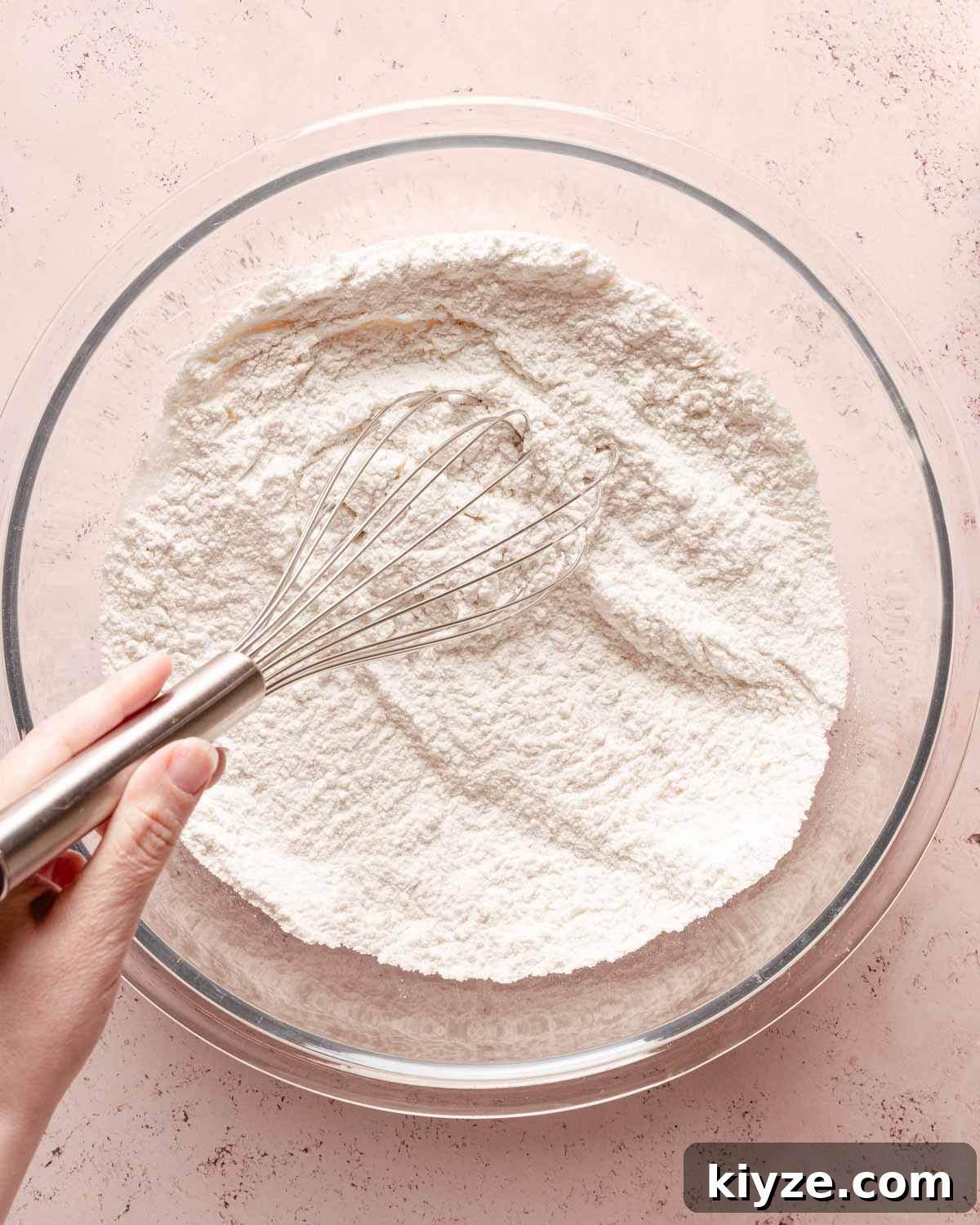 Fluffy Buttermilk Muffins Recipe for Tender Homemade Muffins 5 dry muffin ingredients in a bowl being whisked.