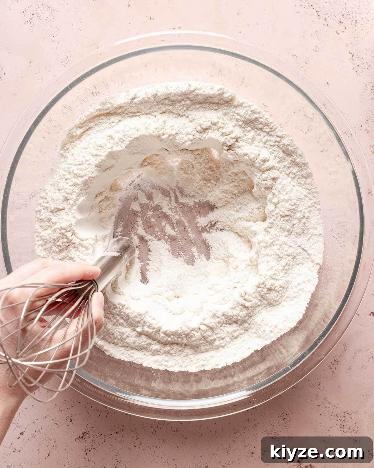 Fluffy Buttermilk Muffins Recipe for Tender Homemade Muffins 6 whisk handle making a well in the center of dry muffin ingredients.