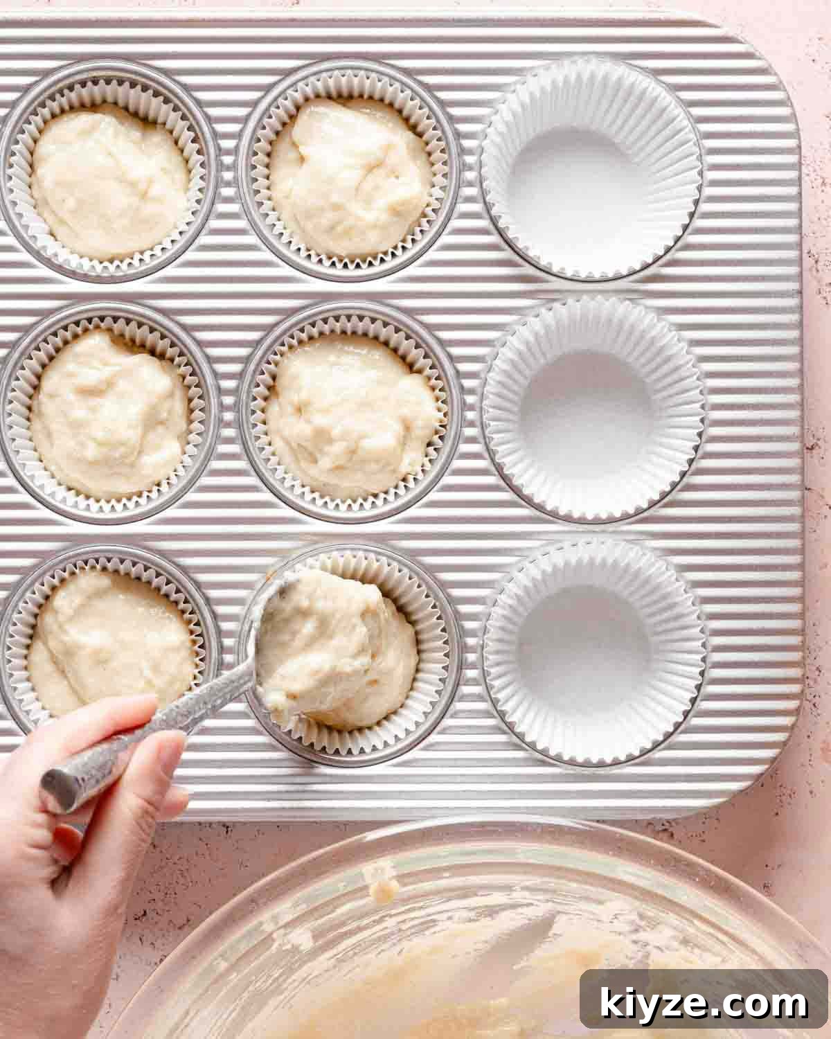 Fluffy Buttermilk Muffins Recipe for Tender Homemade Muffins 10 spoon scooping muffin batter into muffin tin.