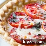 Tomato pie with layers of tomatoes interleaved with cheese, oregano, mayonnaise, salt and pepper.