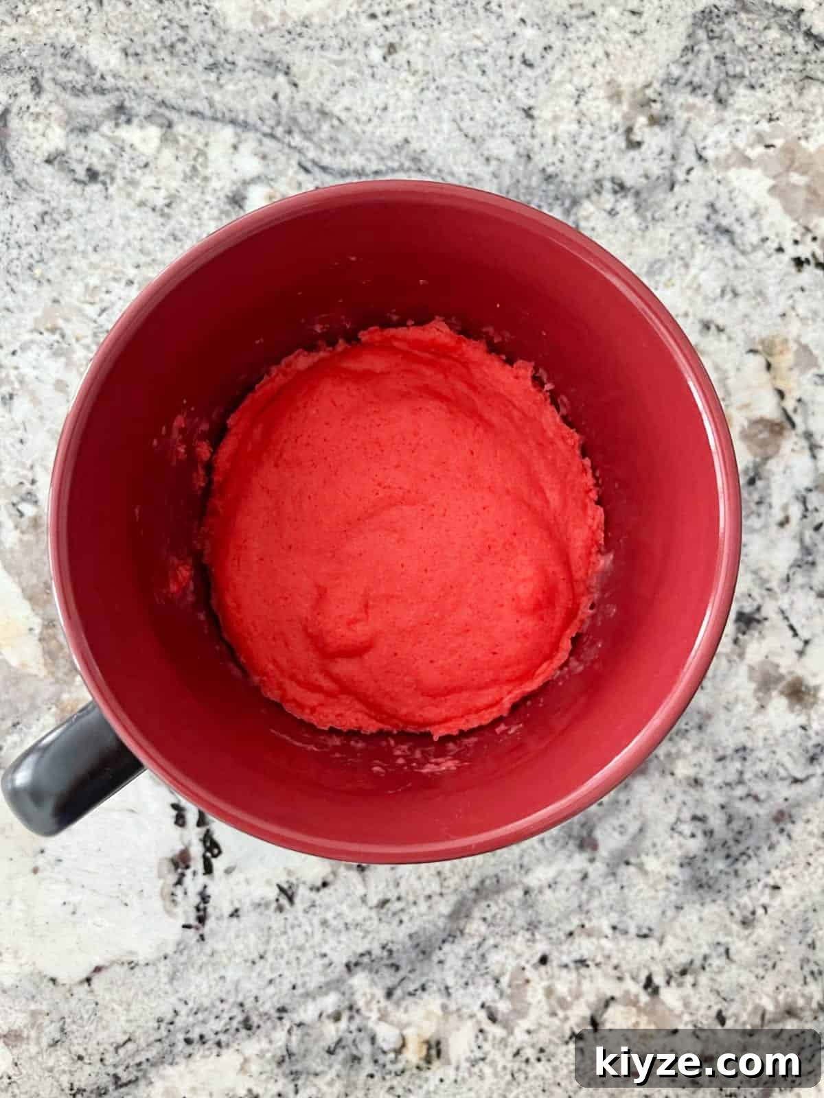 Microwave Mug Jello Cake Recipe: Quick Single-Serve Dessert 6 Fresh cooked raspberry Jell-o microwave cake in red mug on granite counter.