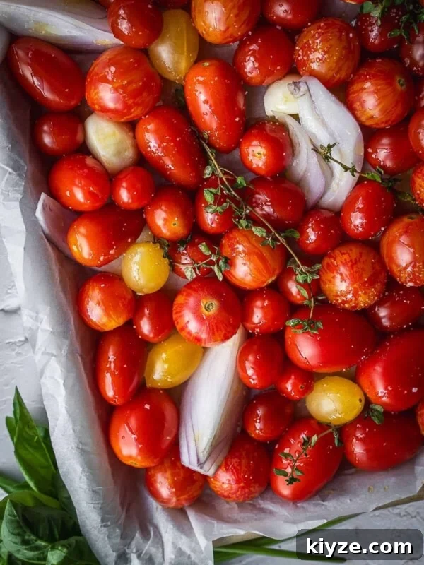 Hogao: Authentic Colombian Tomato and Scallion Creole Sauce Recipe 8 Cherry tomatoes with onions, garlic and thyme in a baking tray.