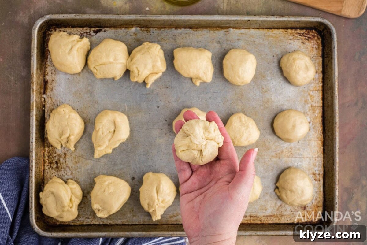Garlic Herb Cheese Rolls Recipe — Soft, Cheesy, Irresistible 11 pinched dough ball in a hand