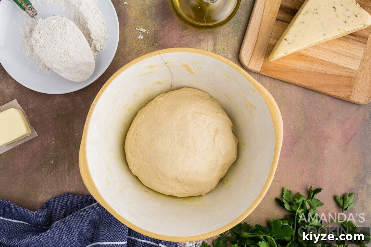 Garlic Herb Cheese Rolls Recipe — Soft, Cheesy, Irresistible 8 dough ball in a bowl