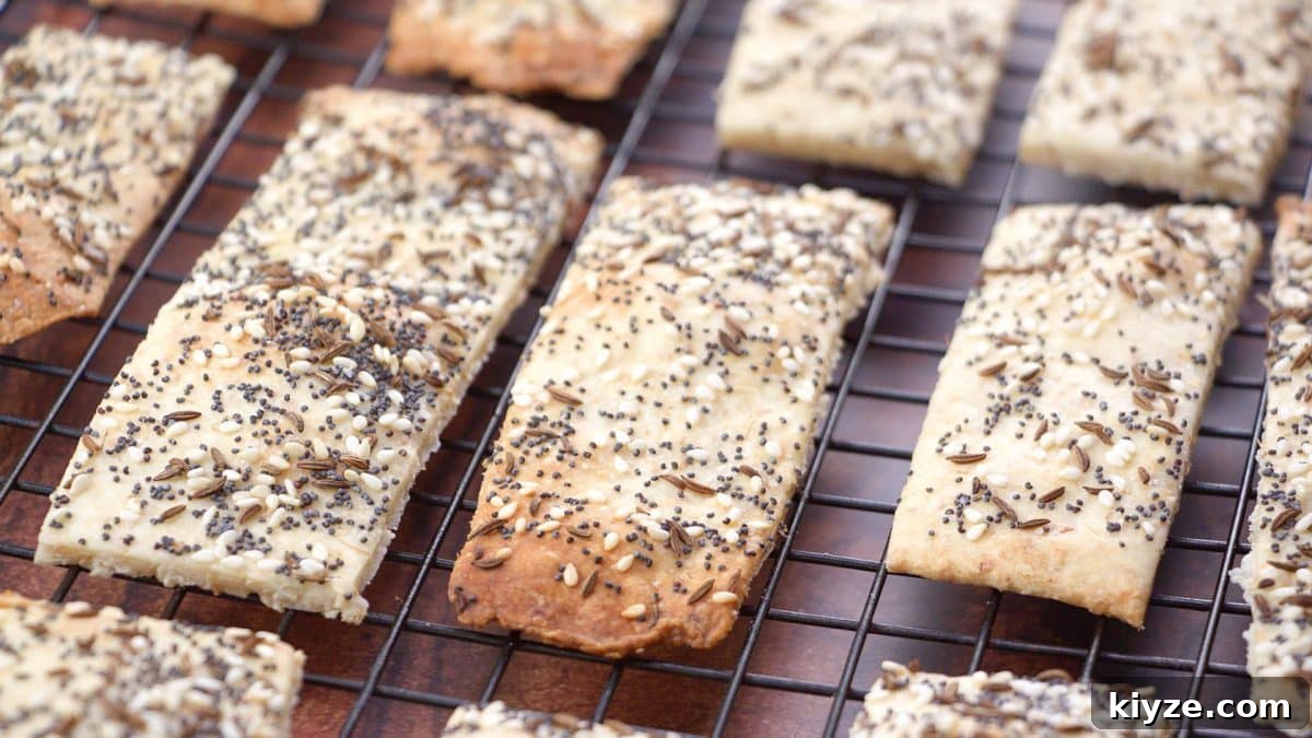 Three-Seed Homemade Crackers Recipe for Crispy, Crunchy Snacks 2 Homemade crackers on a cooling rack, close up.