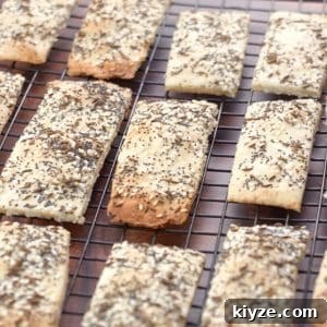 Three-Seed Homemade Crackers Recipe for Crispy, Crunchy Snacks 12 Angled view of homemade seeded crackers on a cooling rack - Hostess At Heart