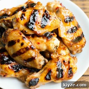 Sticky Peach-Glazed Chicken Wings Recipe 7 Peach Glazed Chicken Wings are a sweet and tangy appetizer you can throw on the grill right alongside your burgers and dogs!