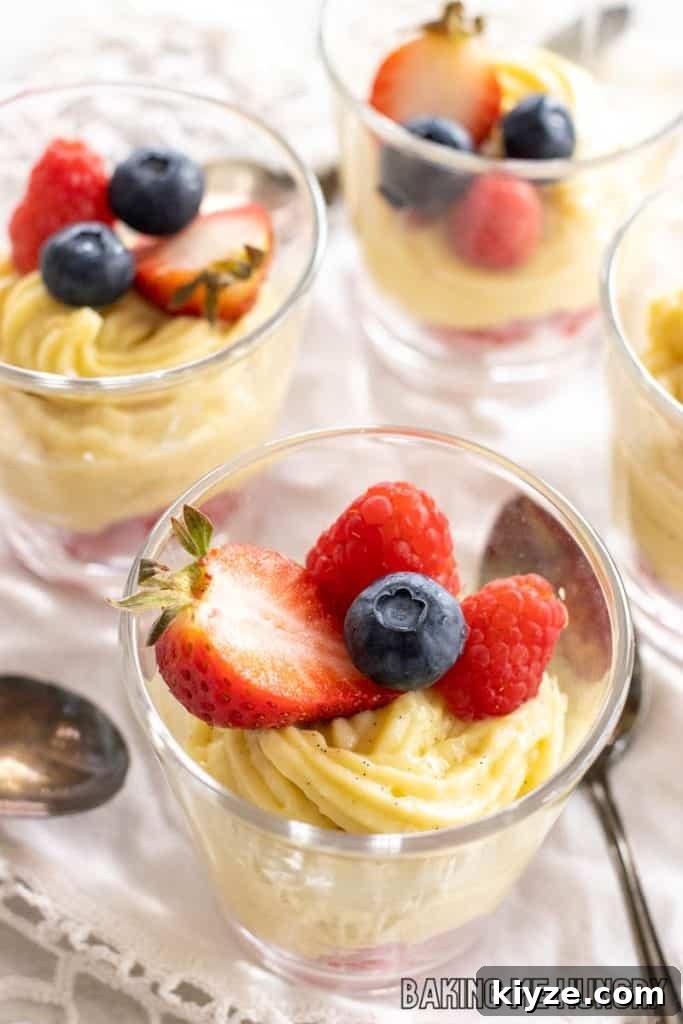 Silky Vanilla Bean Custard Recipe 2 vanilla bean custard recipe in jars with raspberries, blueberries, and halved strawberry
