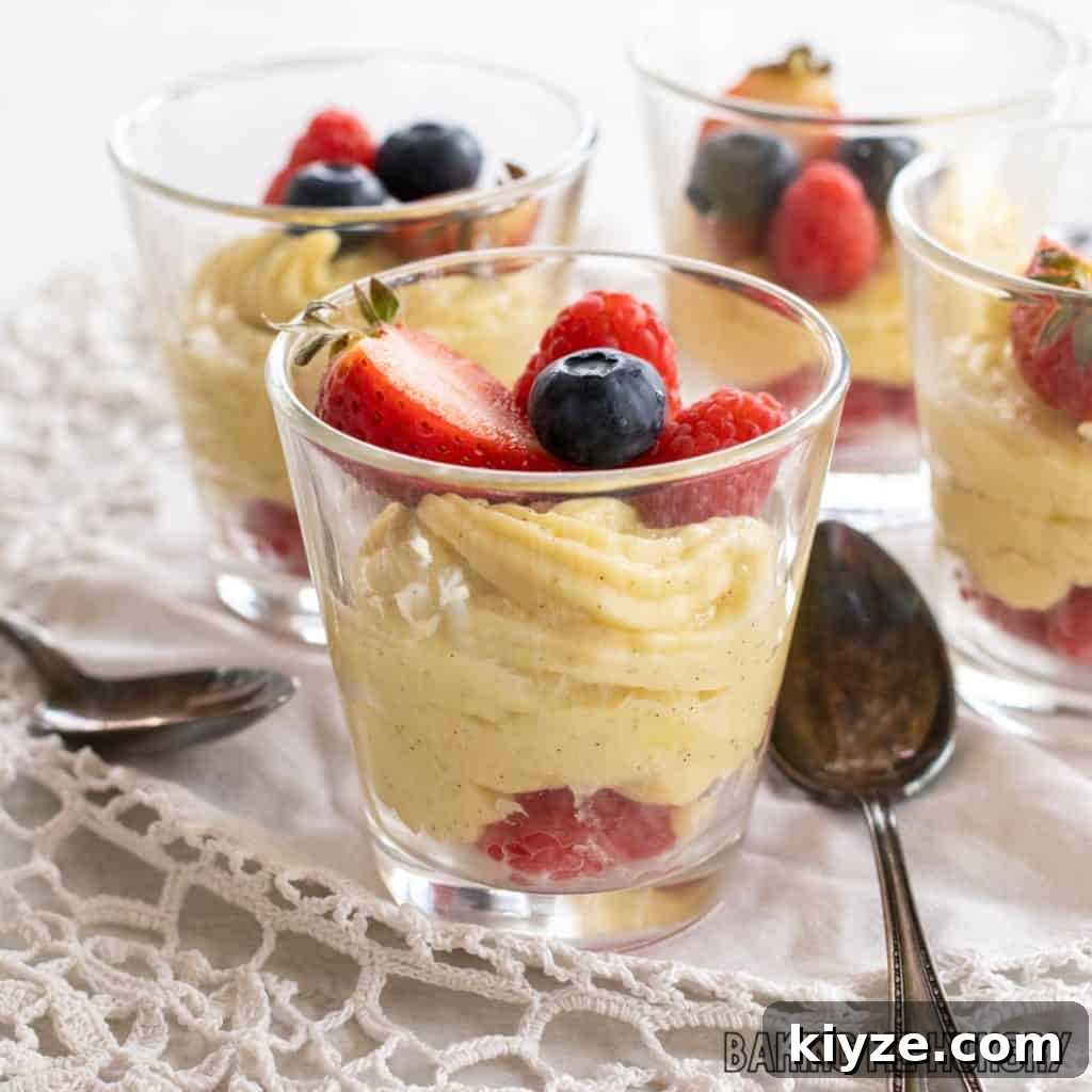 Silky Vanilla Bean Custard Recipe 3 four jars with vanilla bean custard in jar topped with berries