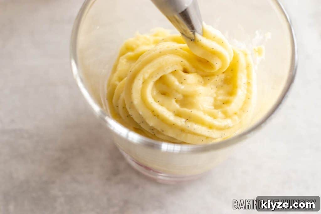 Silky Vanilla Bean Custard Recipe 9 custard being piped into jar