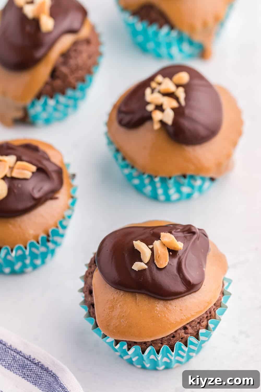 Decadent Peanut Butter Brownie Cupcakes Recipe 2 peanut butter brownie cupcakes on a white board