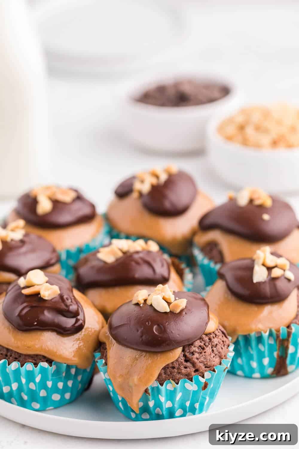 Decadent Peanut Butter Brownie Cupcakes Recipe 3 peanut butter brownie cupcakes on a white plate