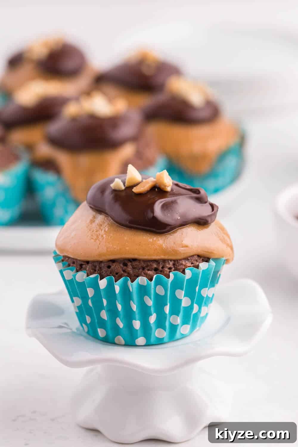 Decadent Peanut Butter Brownie Cupcakes Recipe 5 peanut butter brownie cupcake on a cupcake stand
