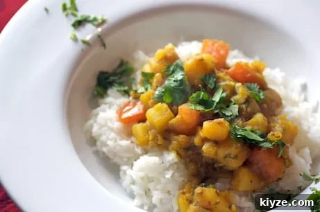 Cumin-Scented Potatoes with Tomatoes (Ghurma Aloo) 2 Bowl of curried potatoes over rice.