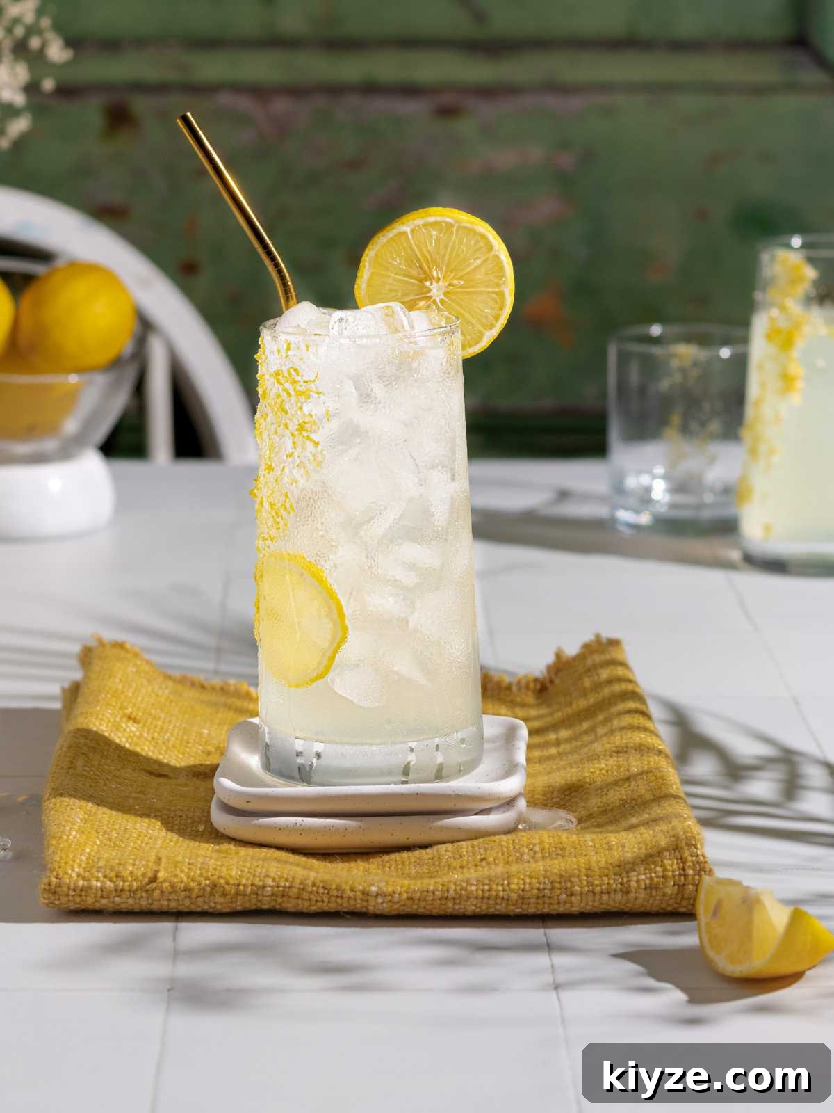 Homemade Lemonade Recipe — Fresh Italian Limonata 2 lemon drink with sparkling water in a serving cup on a table.
