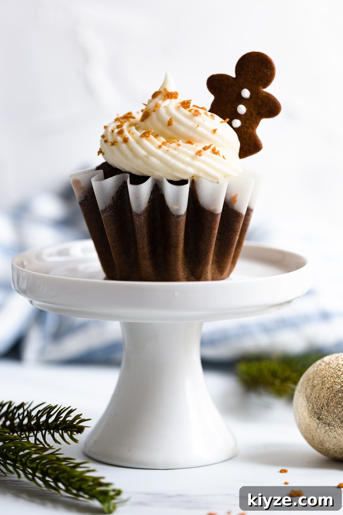 a side super close up of gingerbread cupcake on a cupcake stand