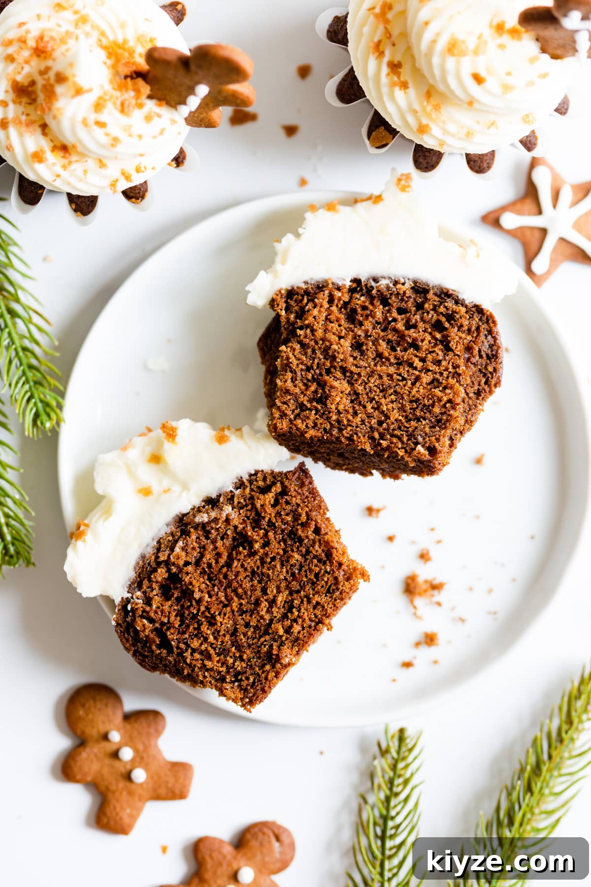top view close up of a gingerbread cupcake with cream cheese frosting cut in half
