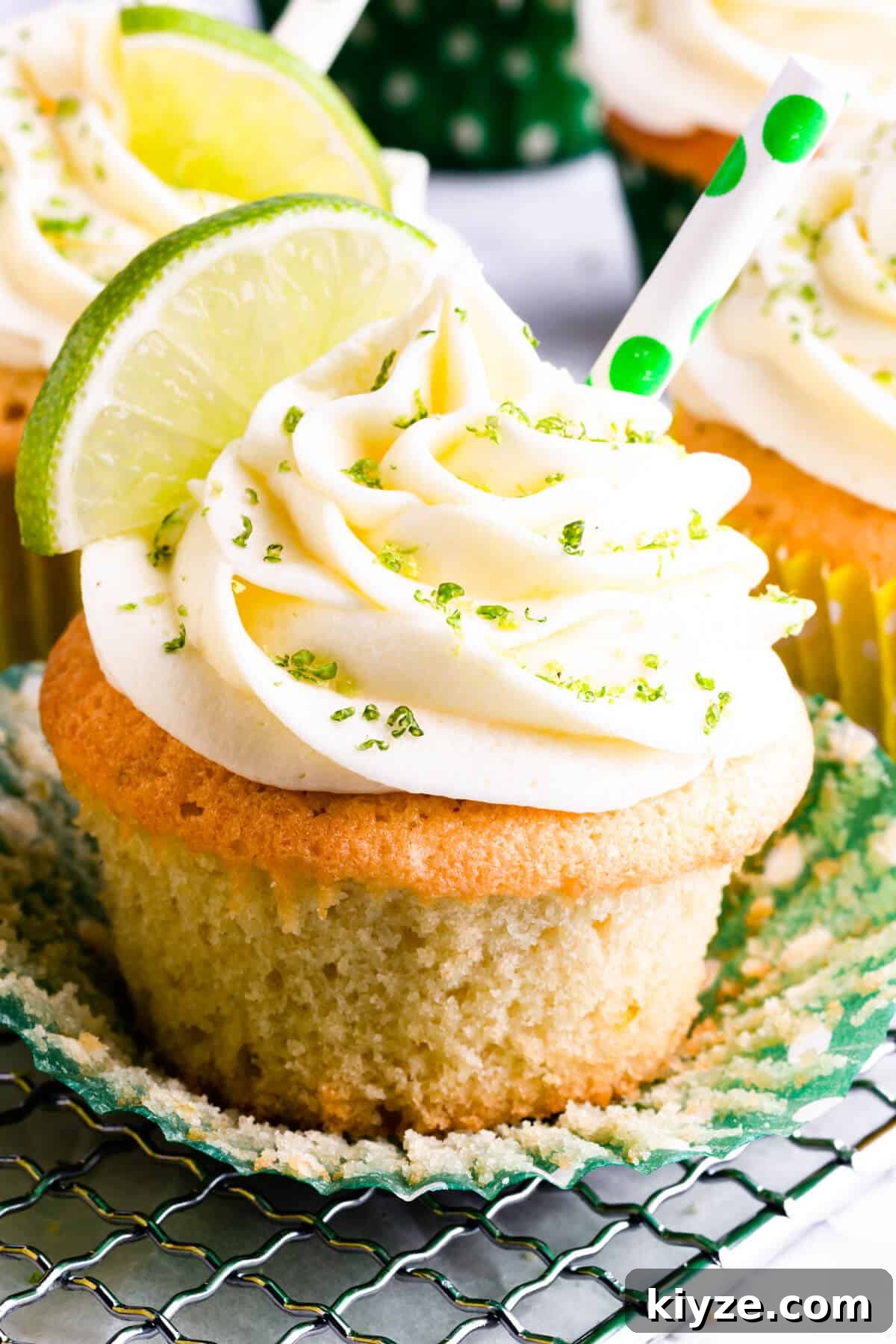 super close up at a cupcake topped with butter icing and lime zest