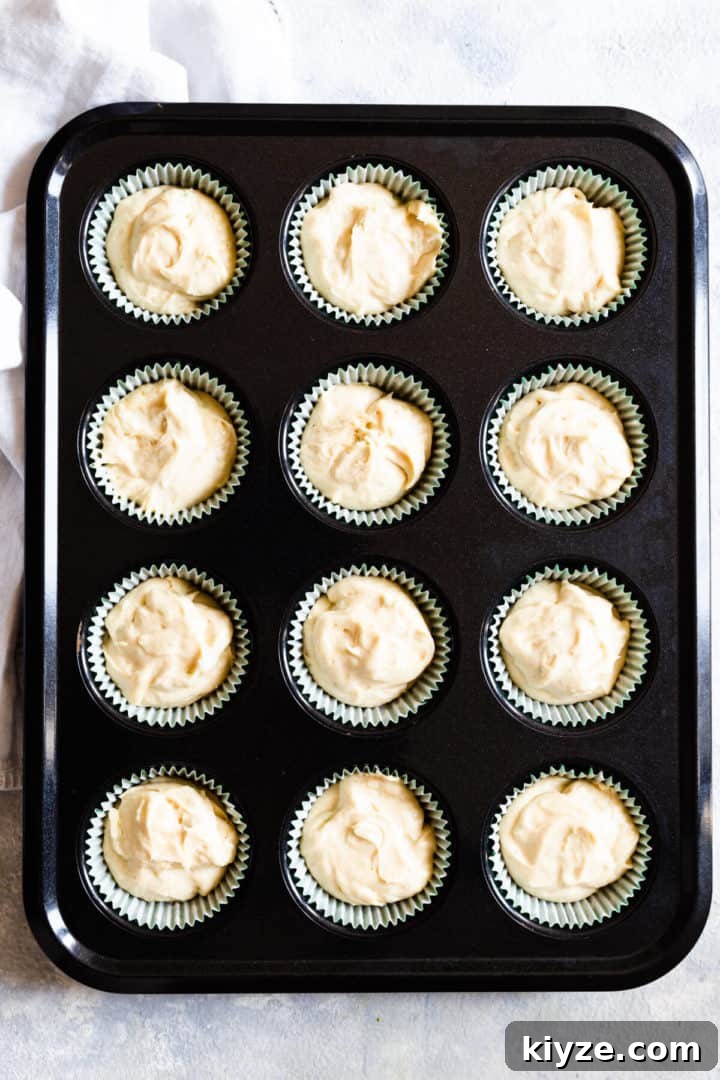 top view of a 12-hole cupcake tin filled with cake batter