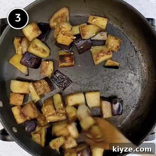 Lamb and Eggplant Fatteh | cookeatworld.com Frying cubes of eggplant in a small pan
