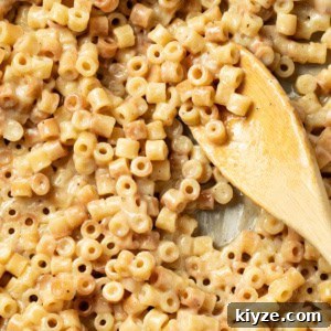 Butter pasta on a wood spoon.