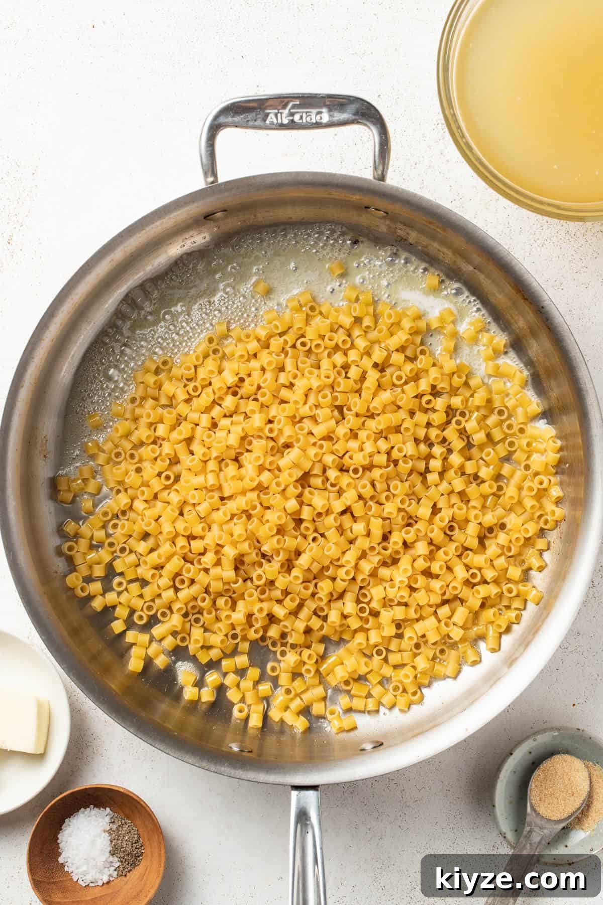 Ditalini pasta and butter in a skillet.