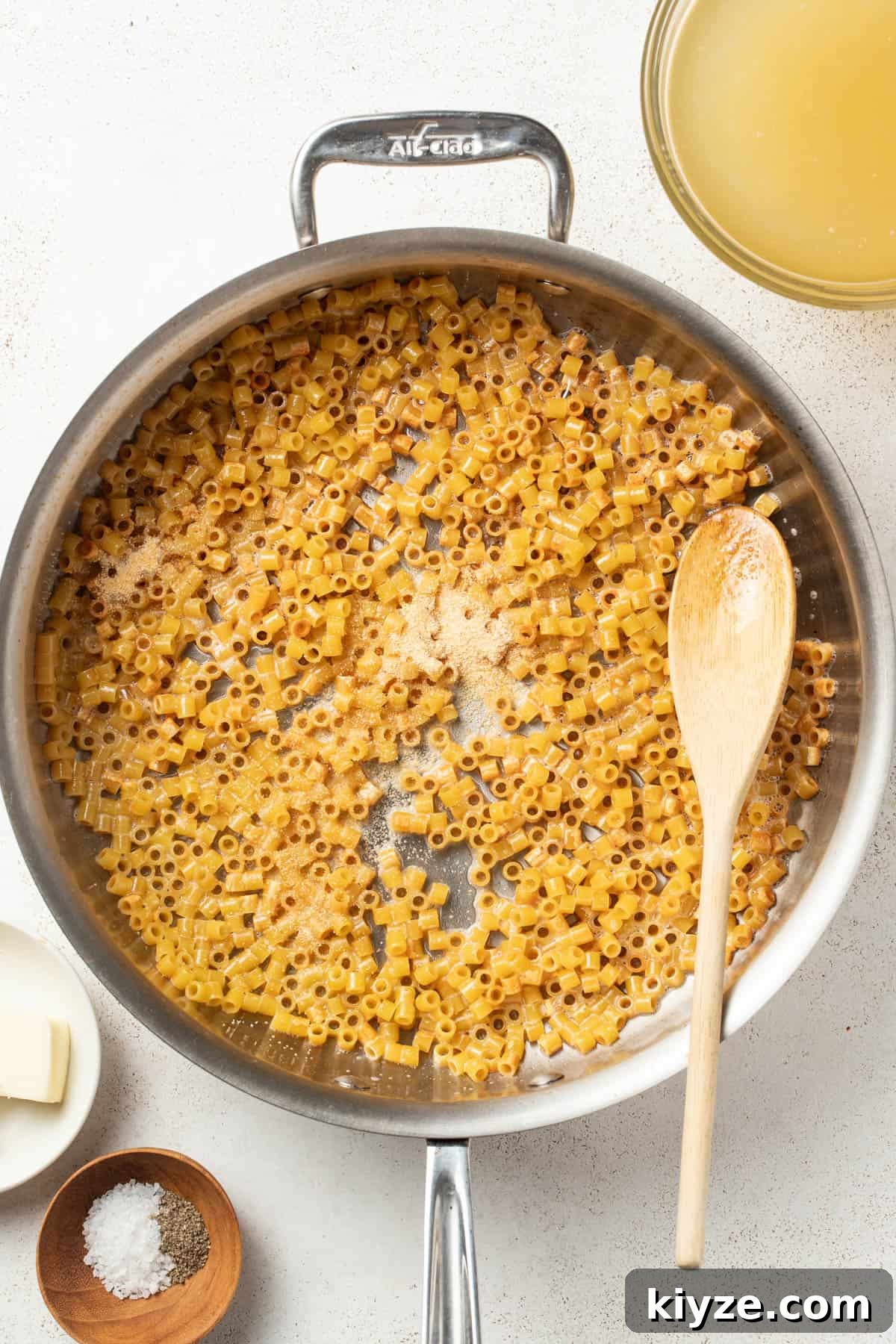 Adding garlic powder to the butter and pasta.