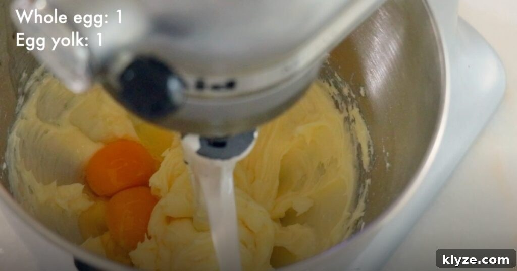 adding eggs in butter to make cookie dough