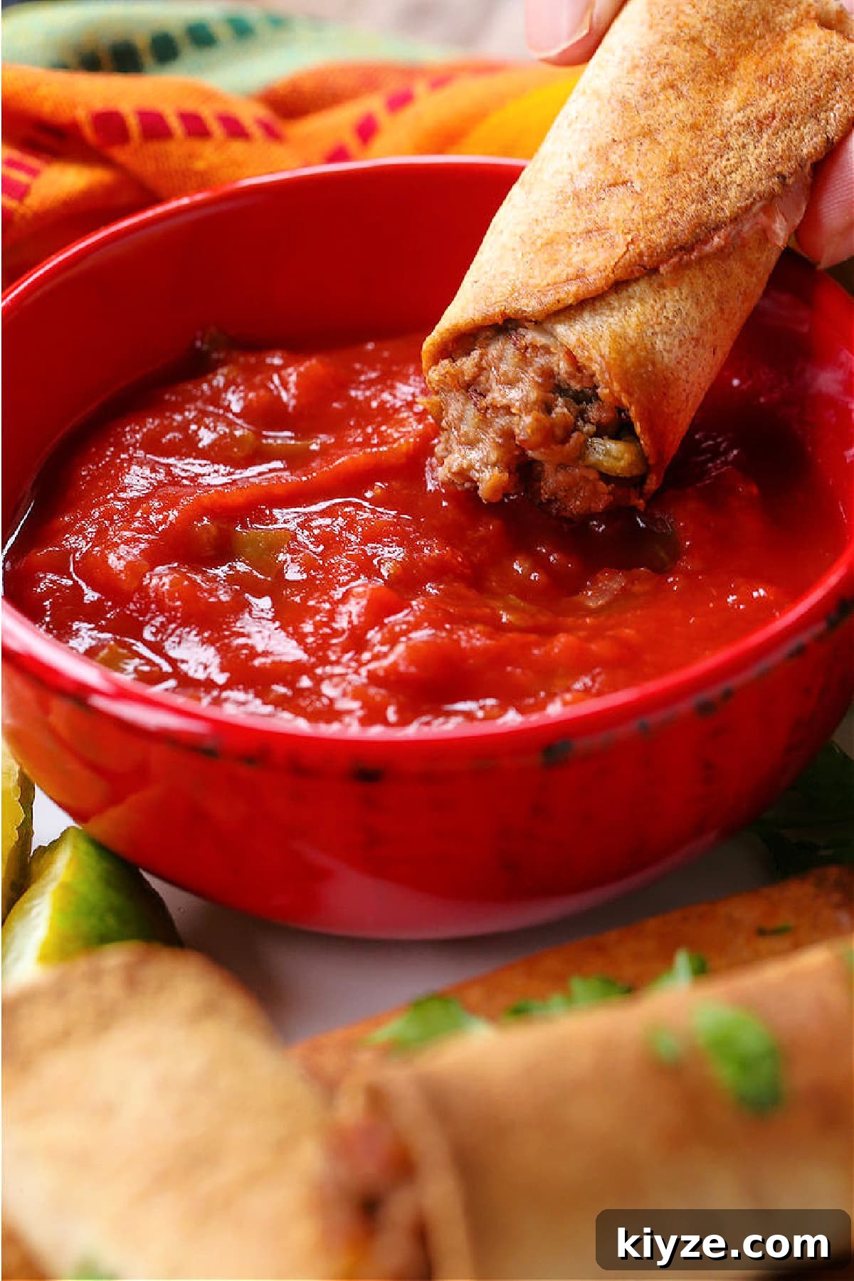 Taquito dipped in salsa beef taquito dipping into salsa