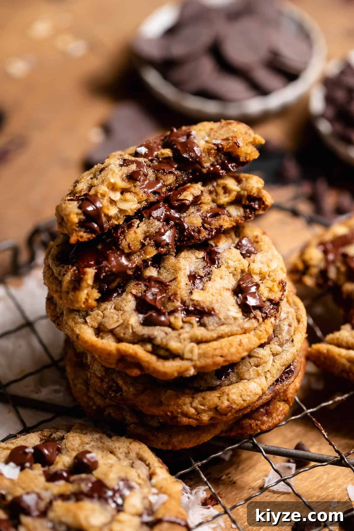 Brown Butter Oatmeal Chocolate Chip Cookies Recipe 2 Stack of oatmeal chocolate chip cookies with a broken cookie showing a gooey chocolate center.