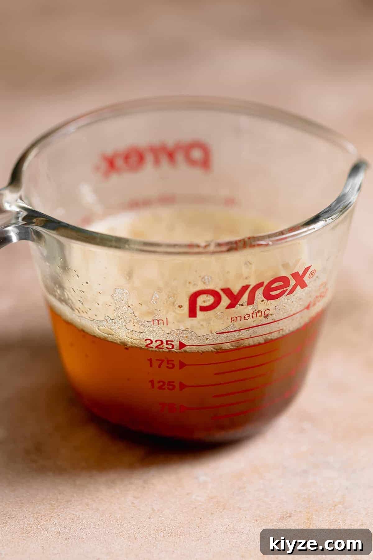 Brown Butter Oatmeal Chocolate Chip Cookies Recipe 3 Brown butter with toasted milk solids in a glass measuring cup after cooking until golden brown.