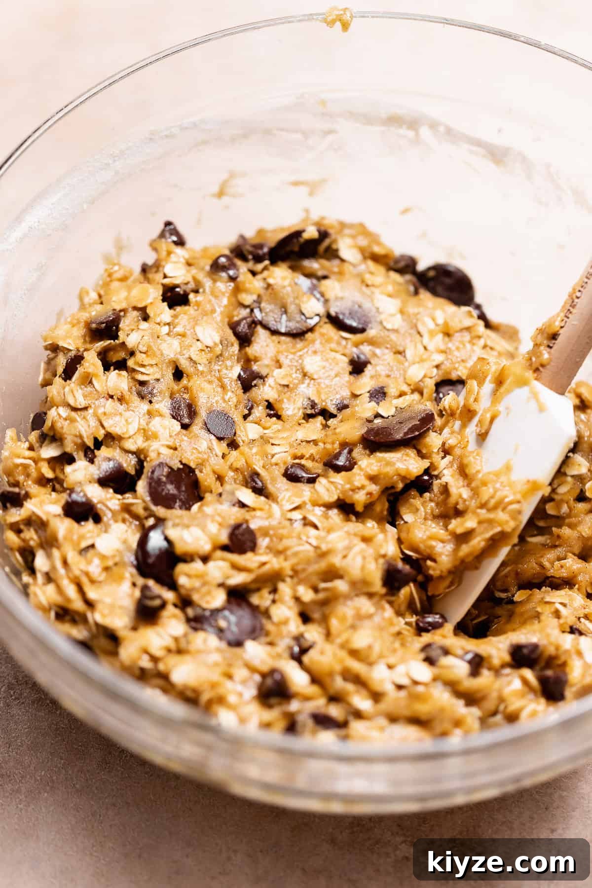 Brown Butter Oatmeal Chocolate Chip Cookies Recipe 5 Brown butter oatmeal chocolate chip cookie dough mixed with old-fashioned oats and chocolate chips in a glass bowl.