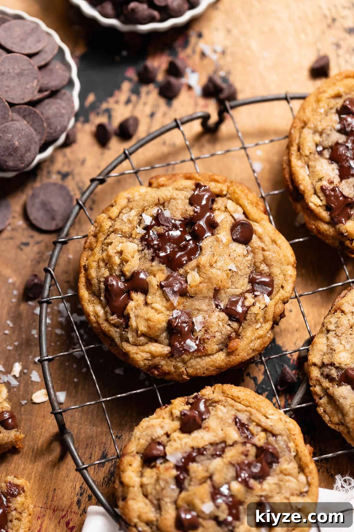 Brown Butter Oatmeal Chocolate Chip Cookies Recipe 7 Brown butter oatmeal chocolate chip cookie topped with melted chocolate and flaky sea salt on a cooling rack.