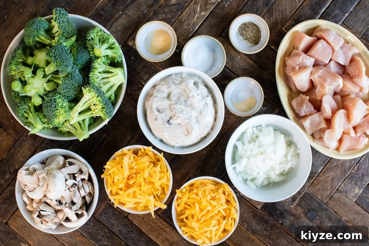 Slow Cooker Cheesy Broccoli Chicken Recipe 3 broccoli, cream of mushroom soup, mushrooms, onion, cheese and diced chicken on a table.