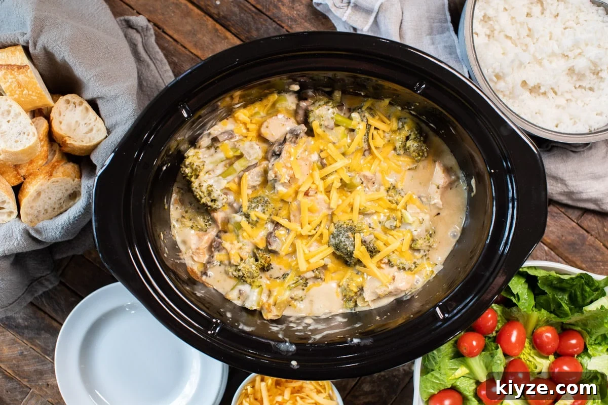 Slow Cooker Cheesy Broccoli Chicken Recipe 5 done cooking cheesy broccoli chicken in slow cooker with salad on the side.