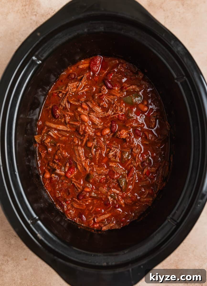Slow Cooker Shredded Beef Chili Recipe 8 Shredded beef chili in crockpot after freshly shredded beef is added into the pot.