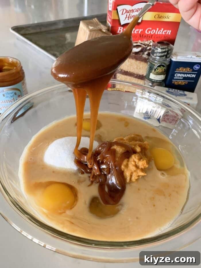 adding caramel to mixing bowl for pumpkin bars