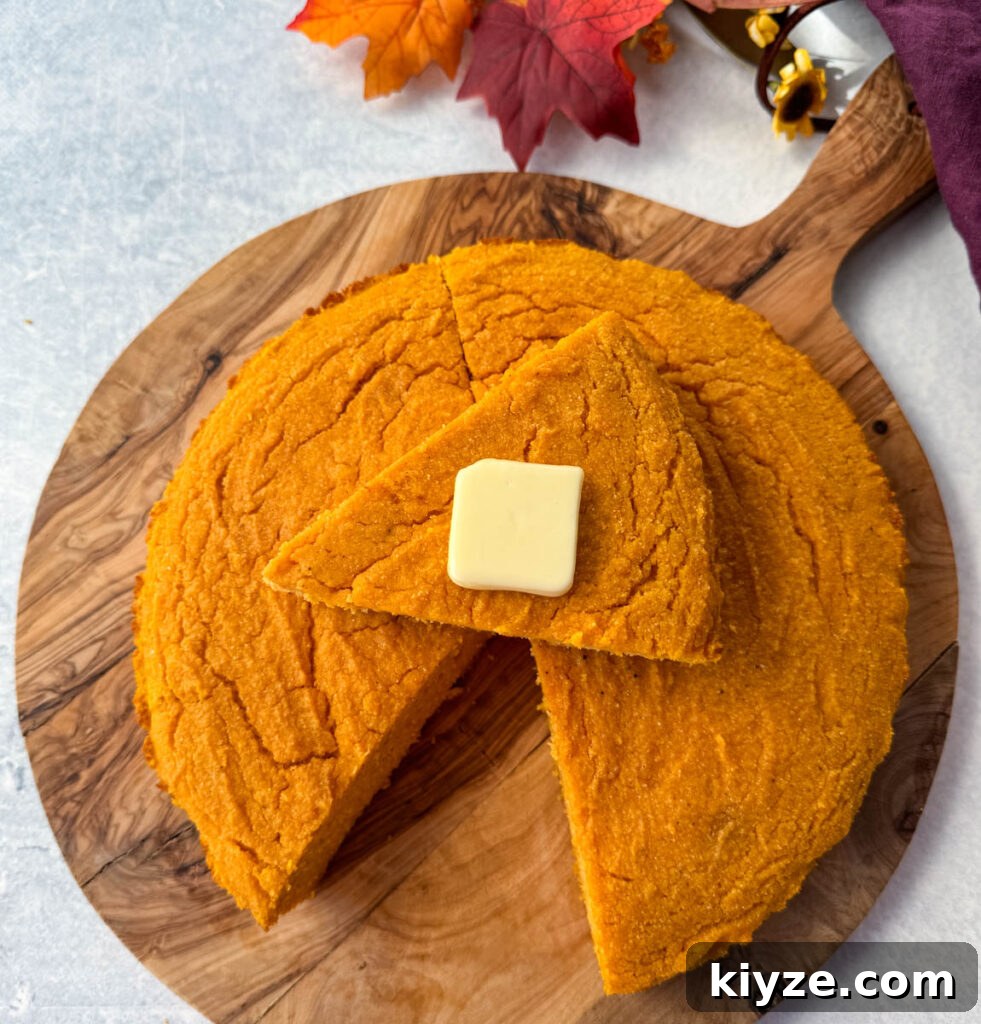 Classic Southern Sweet Potato Cornbread 8 a slice of sweet potato cornbread with butter on top of a pan of sweet potato cornbread