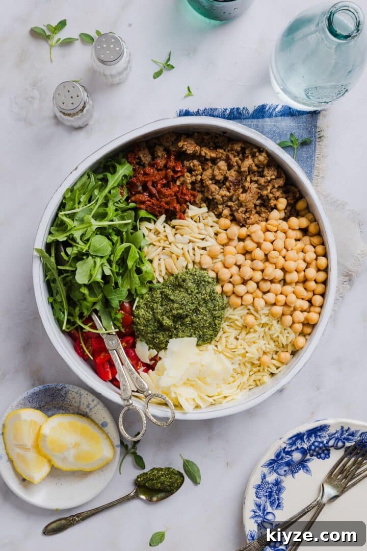 Fresh Pesto and Orzo Salad with Cherry Tomatoes and Basil 6 Ingredients for pesto and orzo salad in a large mixing bowl, unmixed.