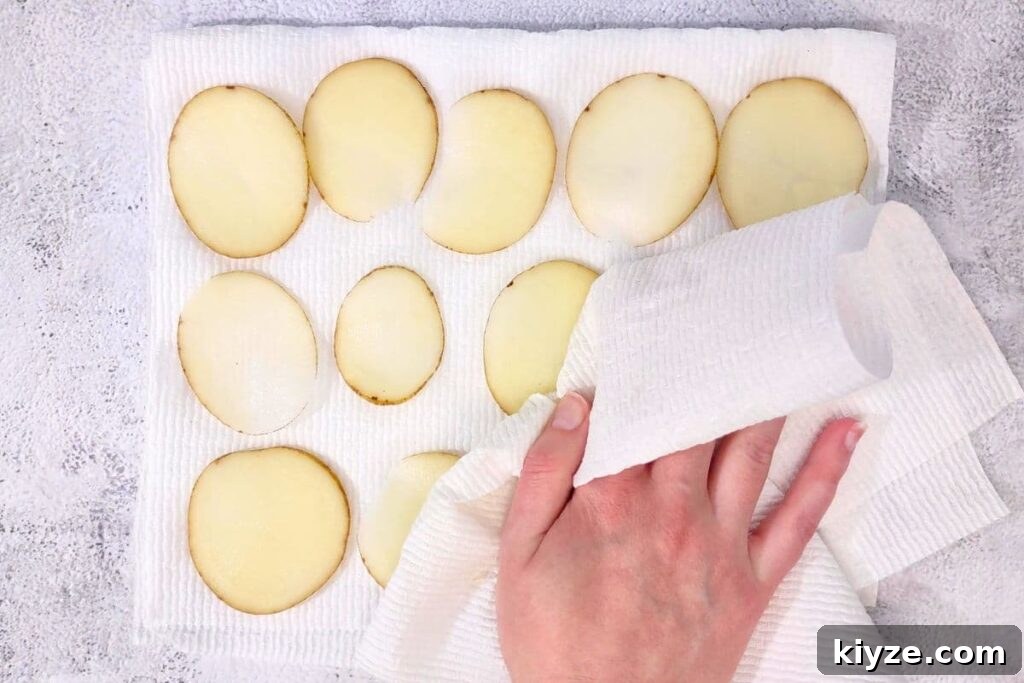dry potato slices with a paper towel
